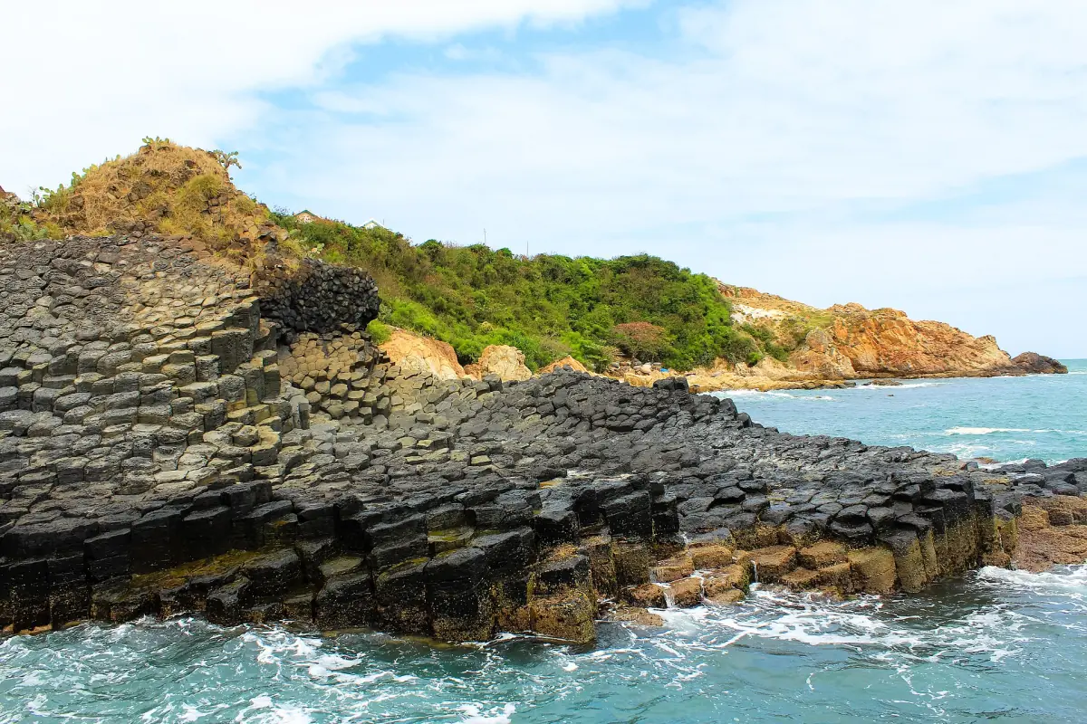 The basalt headland of Ganh Da Dia with green scrub